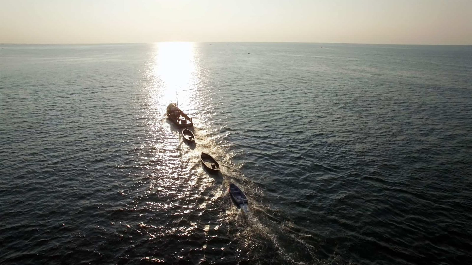Fishing boat heads out to sea at sunrise in Rhode Island