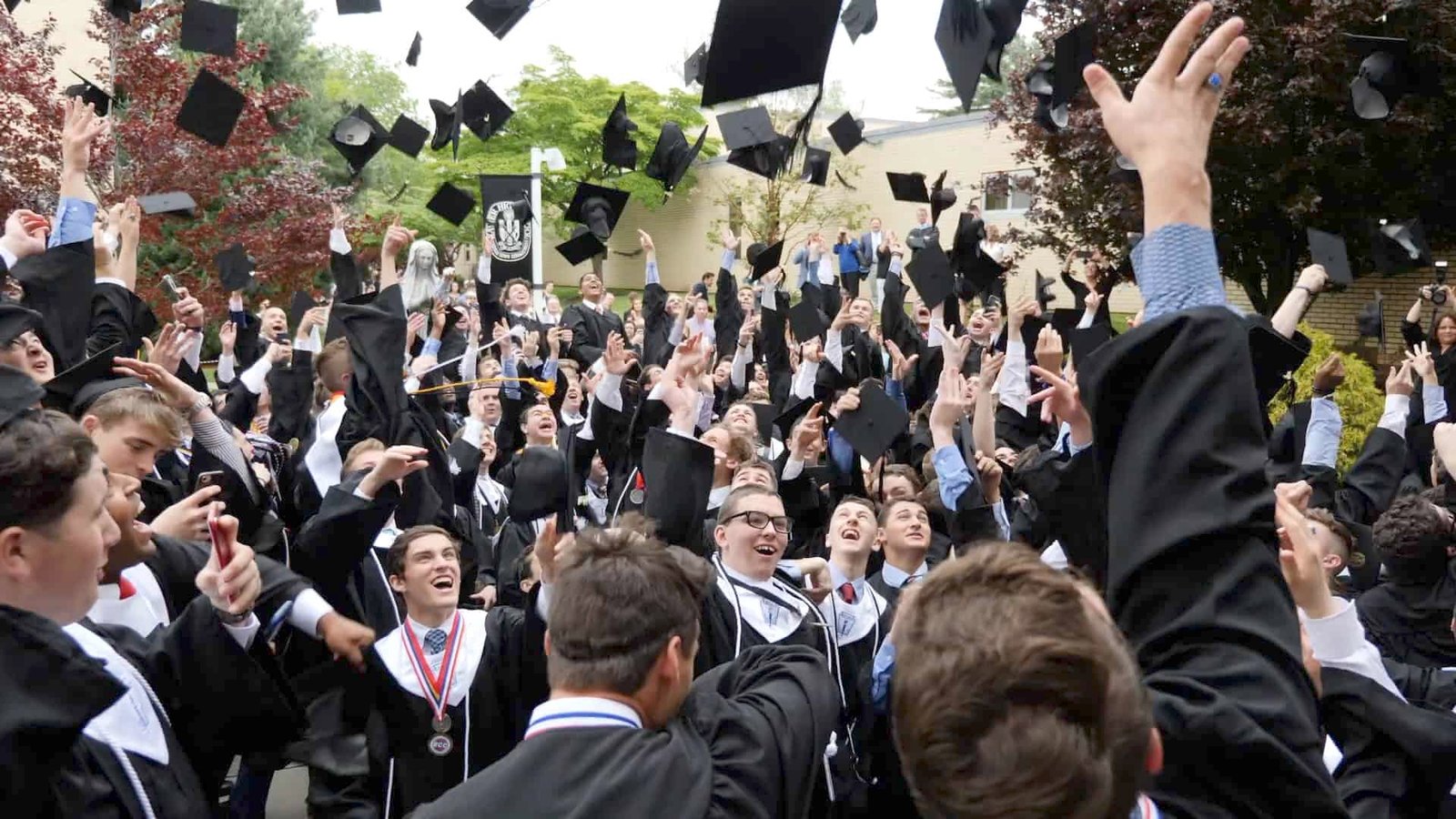 Xavier High School seniors toss mortar boards at graduation